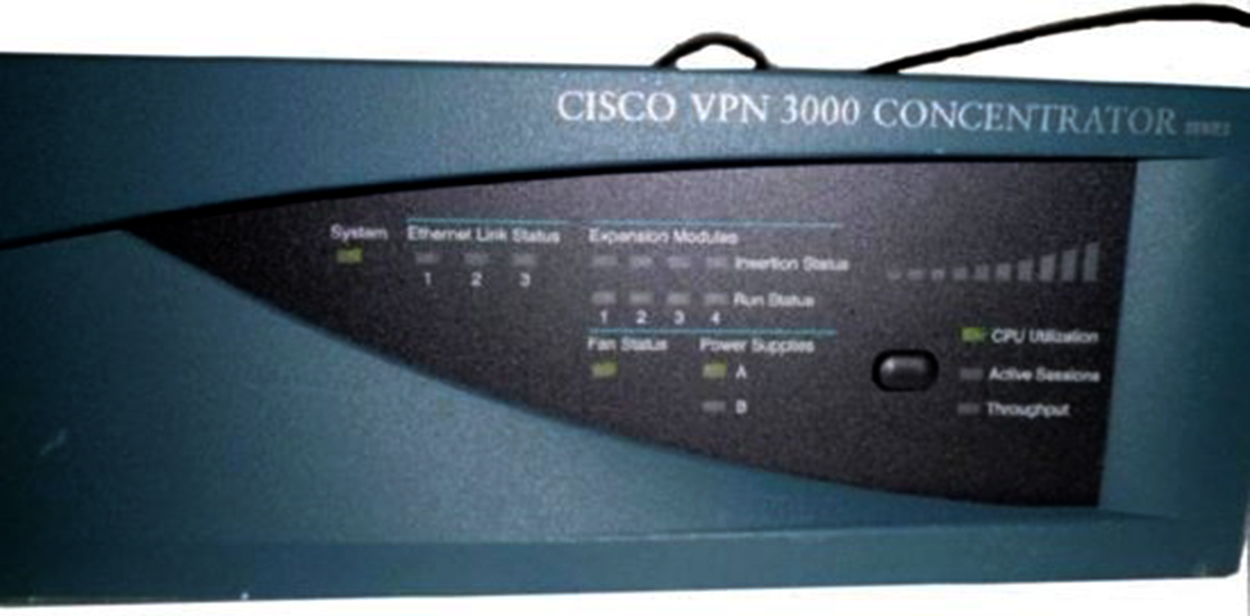 A VPN Concentrator labeled ‘CISCO VPN 3000 CONCENTRATOR’. The concentrator has a rectangular body, and the front panel has several indicator lights and labels.