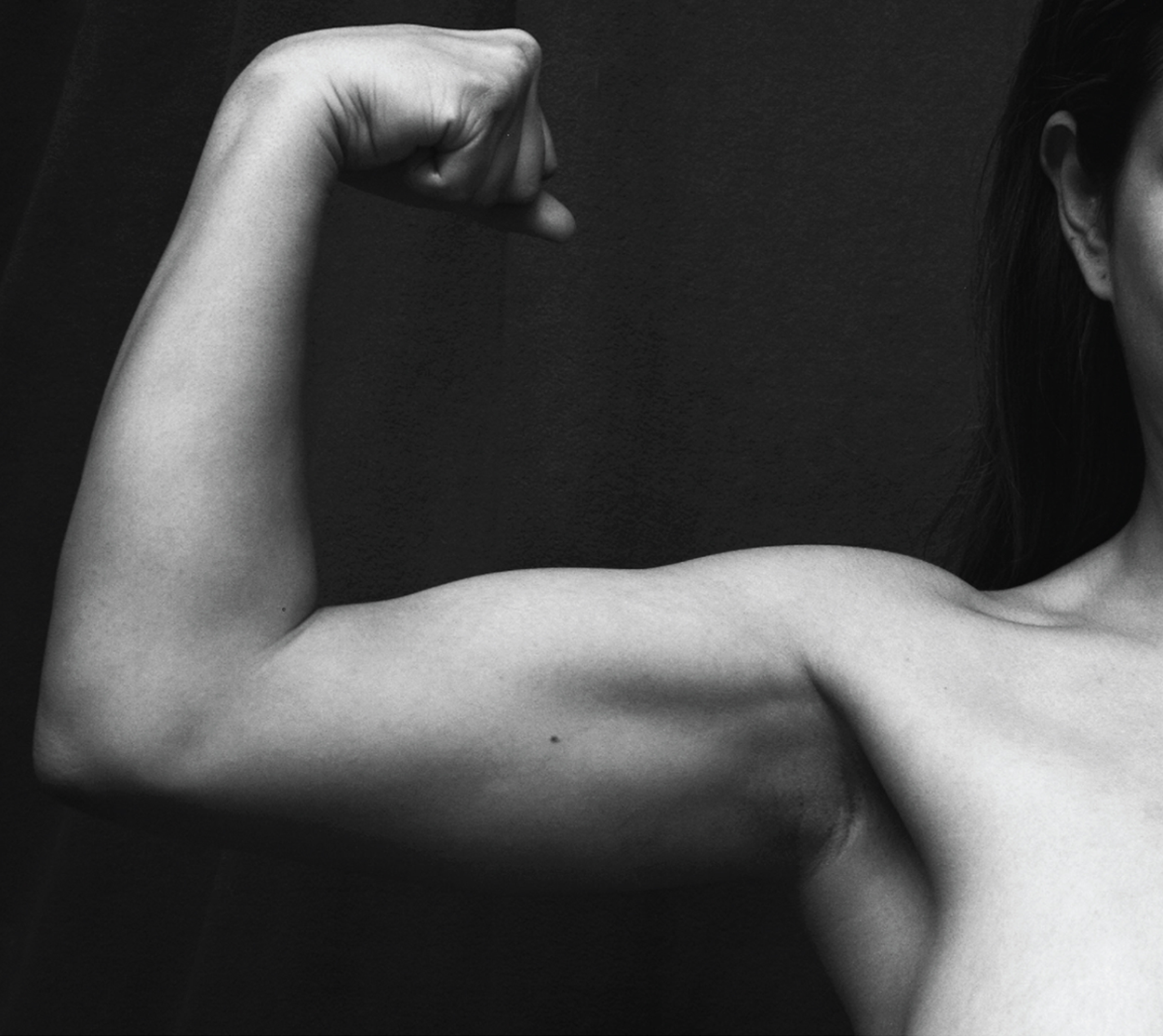 This photo shows a person flexing her biceps.