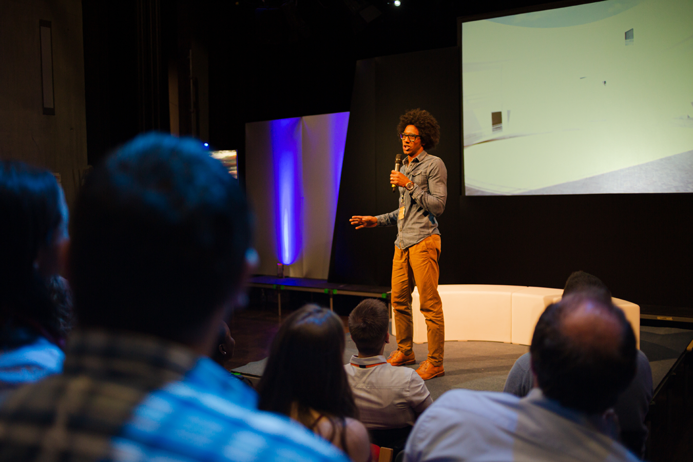 A man stands on stage delivering a speech to an audience.