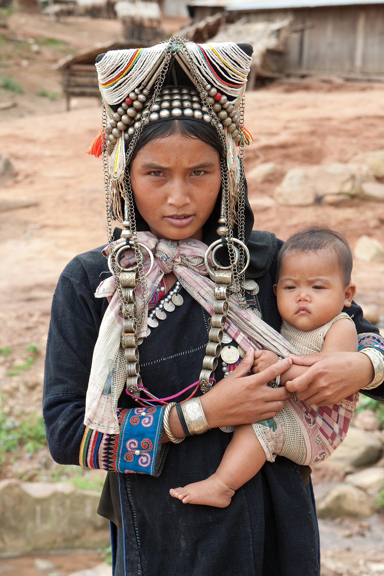 A Tibetan mother carrying her baby in a cloth.