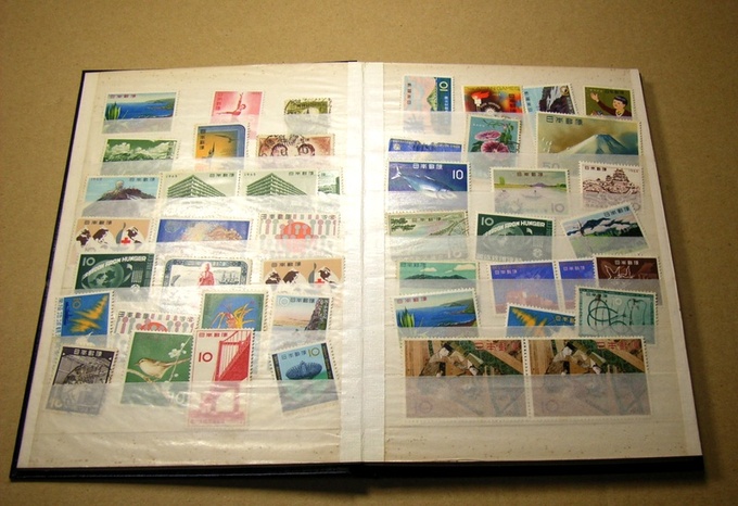 An open book containing a stamp collection is shown.