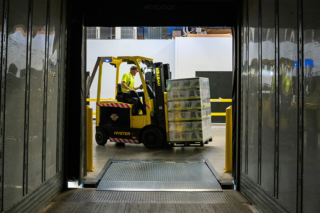 A forklift moving crates in a warehouse