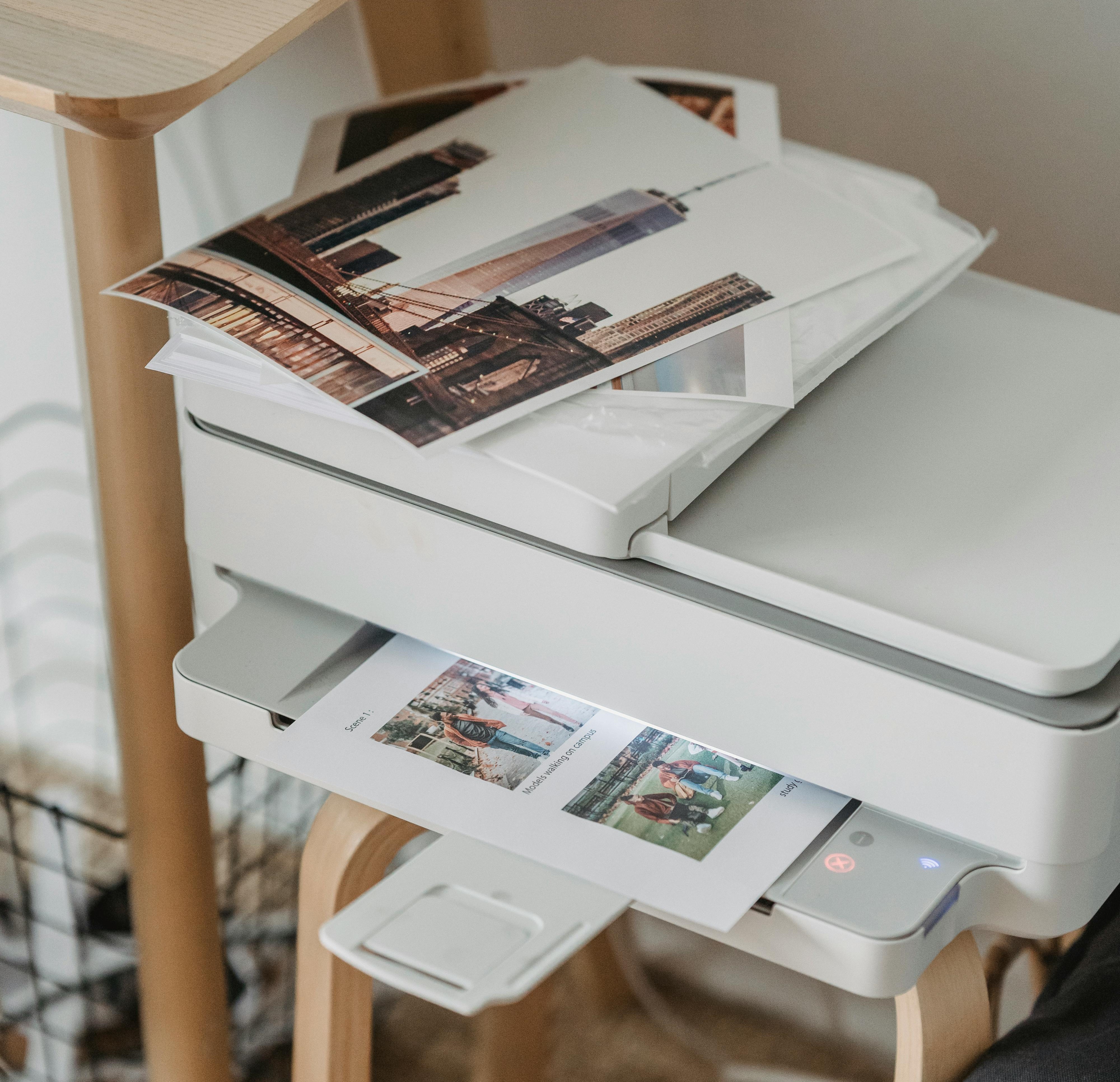 a commercial-sized combination color printer and scanner that is printing images from a trip