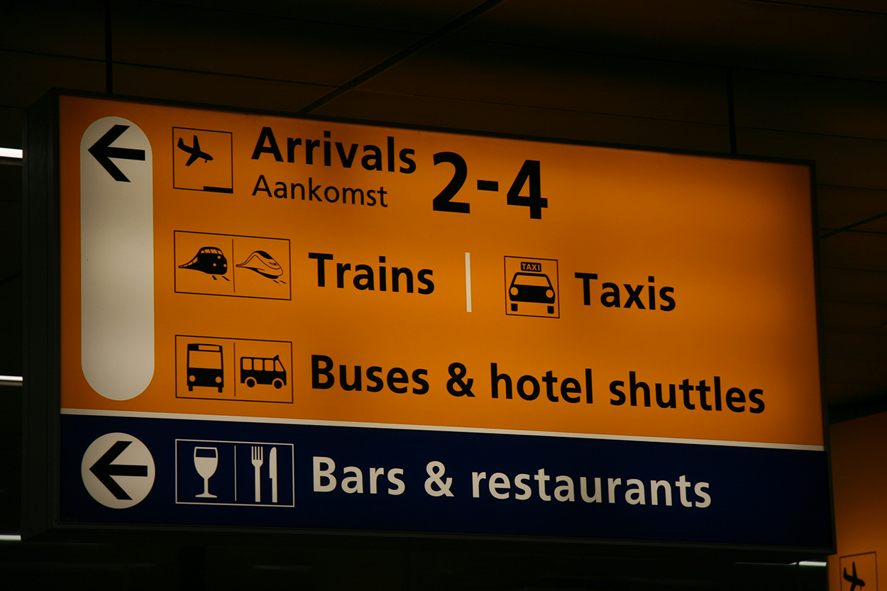 A sign with a combination of icons and directional indicators.