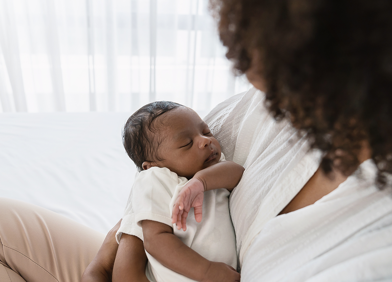 A Parent Holding Their Newborn Baby