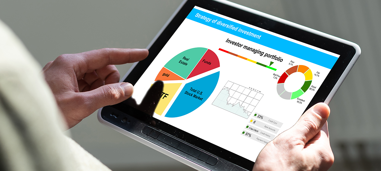 The image shows a person holding a tablet displaying financial charts and graphs related to investment strategies. The screen contains a pie chart with different asset classes such as real estate, funds, gold, and the total U.S. stock market, along with a circular chart indicating portfolio performance ratings. There is also a line graph tracking investment performance over time and percentage-based financial breakdowns. The title on the screen suggests a strategy for diversified investment, indicating a focus on portfolio management and financial analysis.