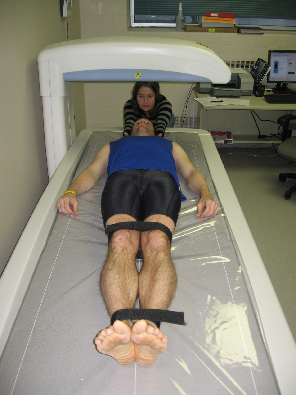  A person lies on his back below a horizontal bar above.