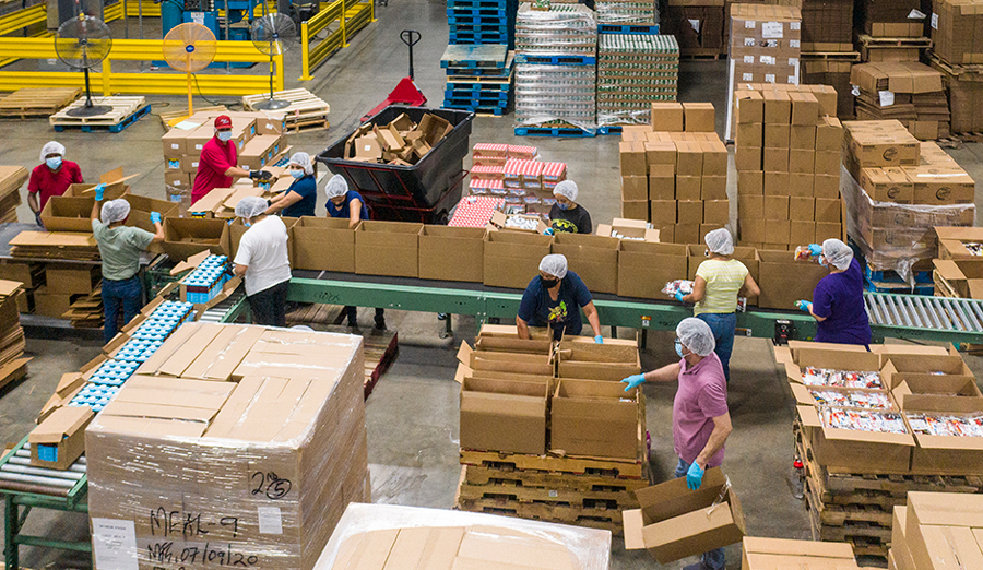 photo of workers packaging goods in a warehouse