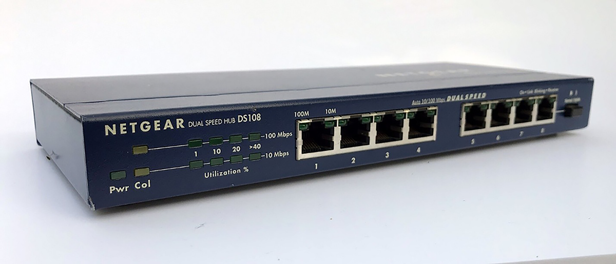 Small Ethernet hub with multiple ports, sending data to all connected devices.