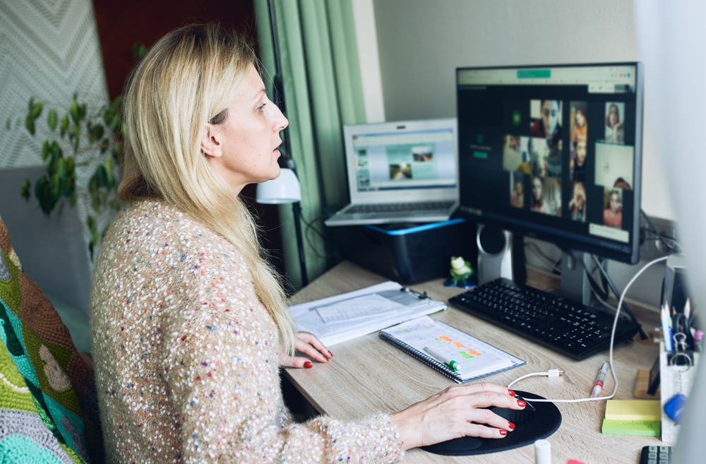 Businesswoman presenting data charts during a virtual meeting with colleagues