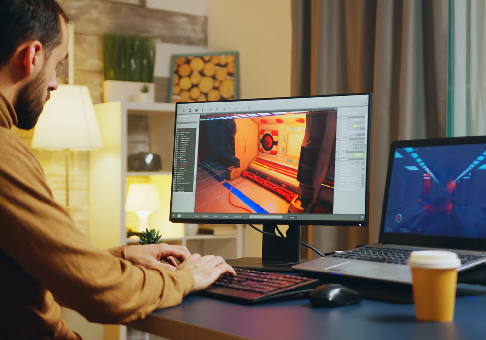  Person working on a computer creating or editing a 3D character model in design software, with a tablet showing a reference image nearby