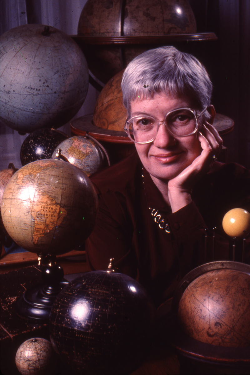 Vera Rubin surrounded by her collection of antique globes